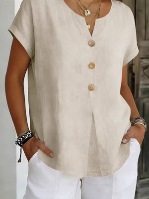 Beige buttoned short sleeve blouse with a V-neck and cuffed sleeves.
