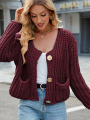 Burgundy chunky knit cardigan with gold buttons and pockets.
