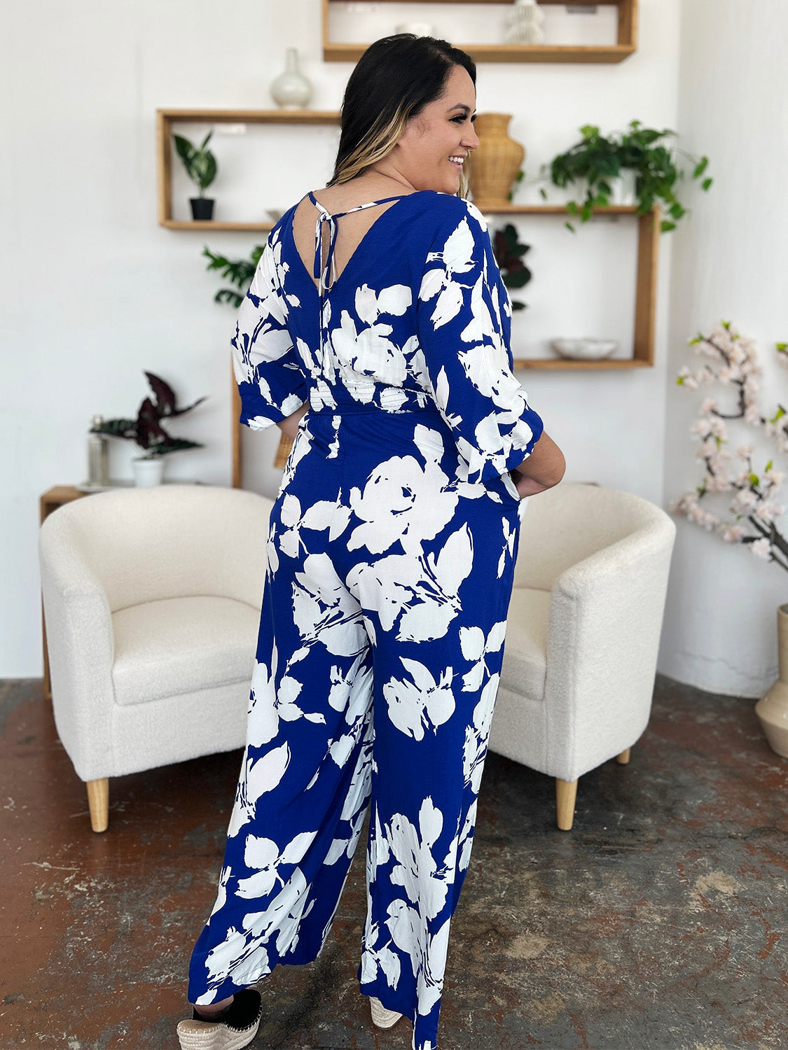 Cobalt blue floral kimono jumpsuit with tie-back detail and wide legs.