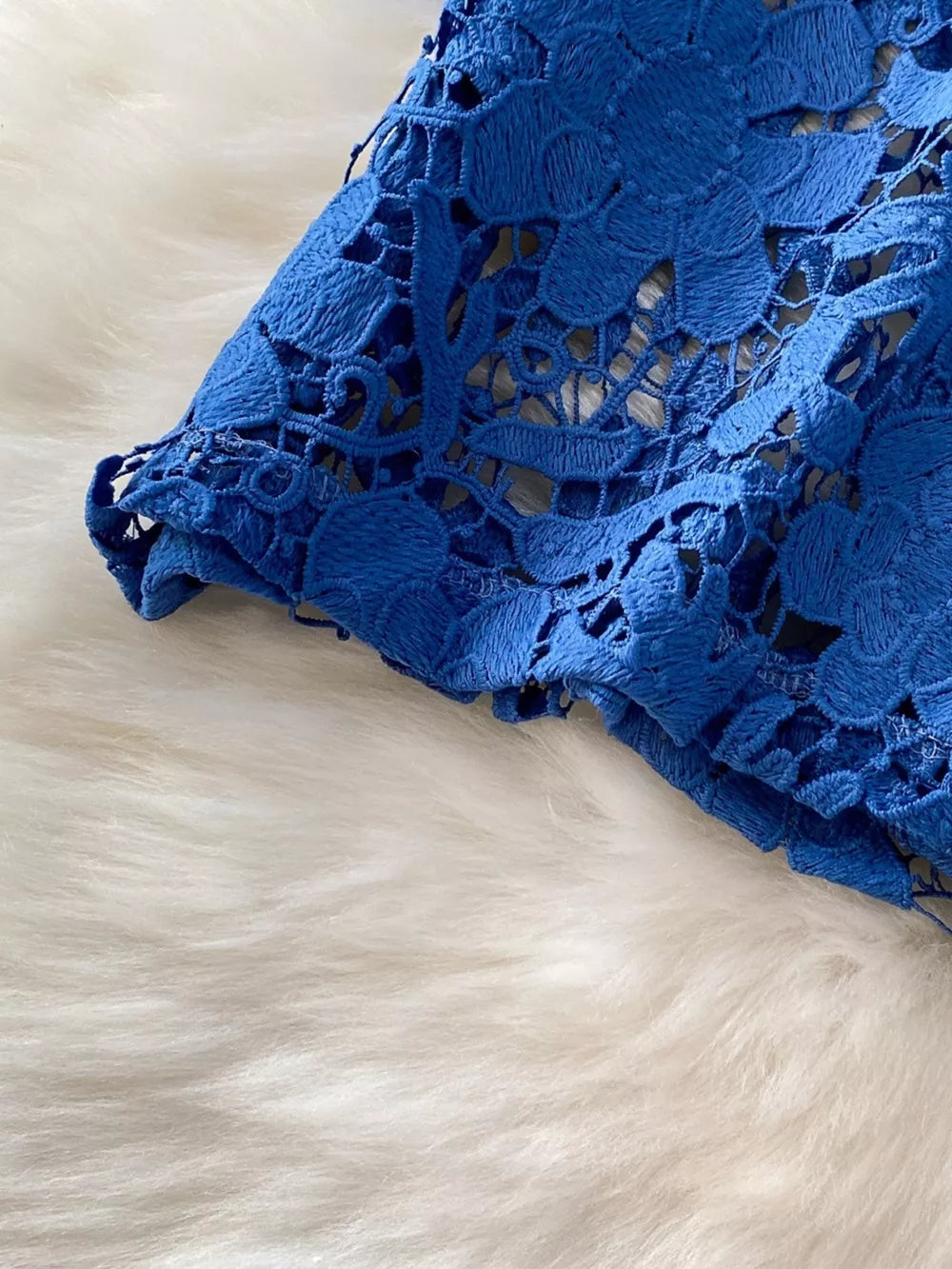 Blue lace-embellished two-piece set with intricate floral detail and scalloped hem.