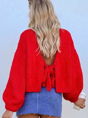 Textured tie-front knit cardigan in scarlet with balloon sleeves and a tie closure at the back.