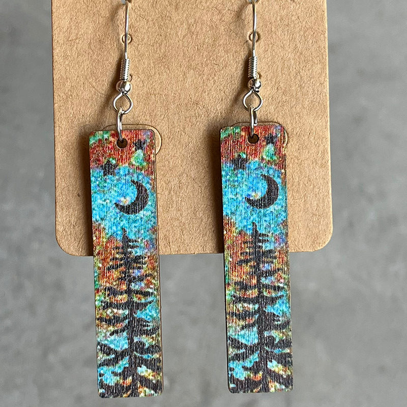 Painted landscape dangle earrings with moon and trees, boho style.
