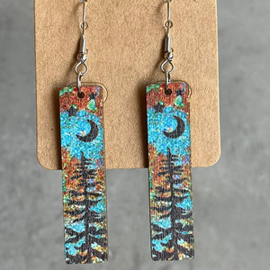 Painted landscape dangle earrings with moon and trees, boho style.