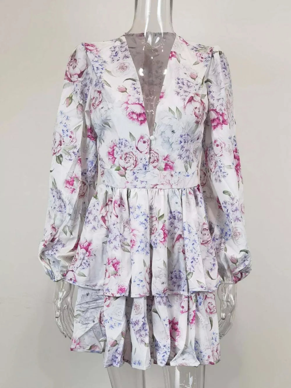 Blooming ruffle layered mini dress with a floral print and V-neck.