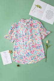 Floral ruffle collar puff sleeve blouse with smocked cuffs and a button-up neckline.