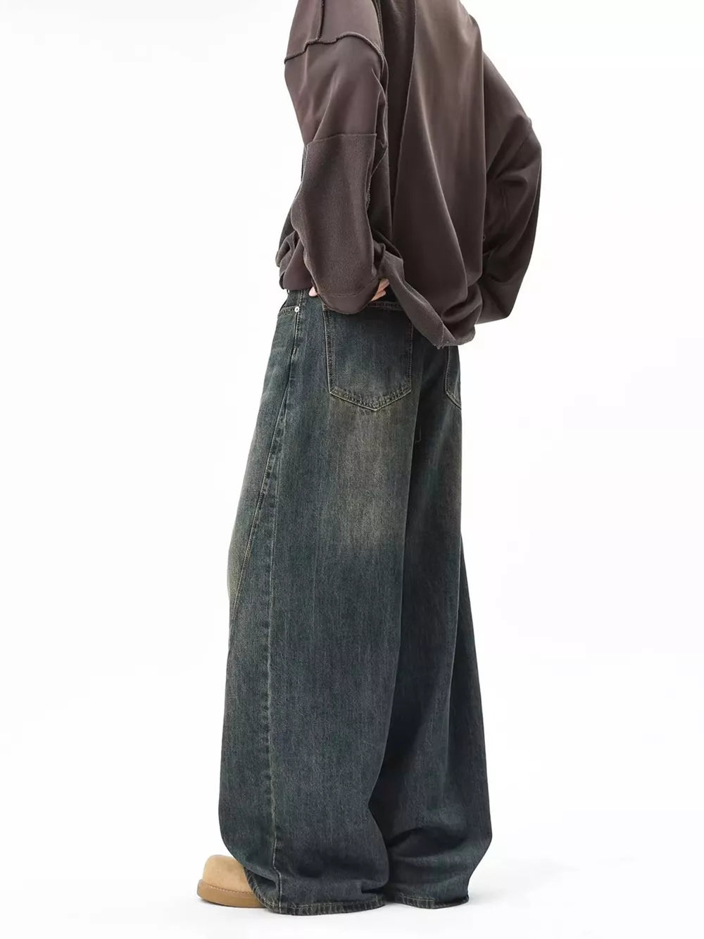 Men's vintage wash baggy blue cotton jeans with a relaxed fit and distressed details.