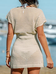 Beige crochet knit beach cover-up dress with short sleeves and a cinched waist.