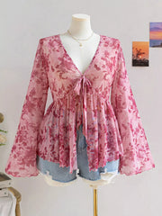 Pink floral chiffon blouse with v-neck and tied detail, bell sleeves.