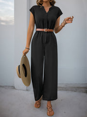 Black cap-sleeve button-down wide-leg jumpsuit with a brown belt and straw hat.