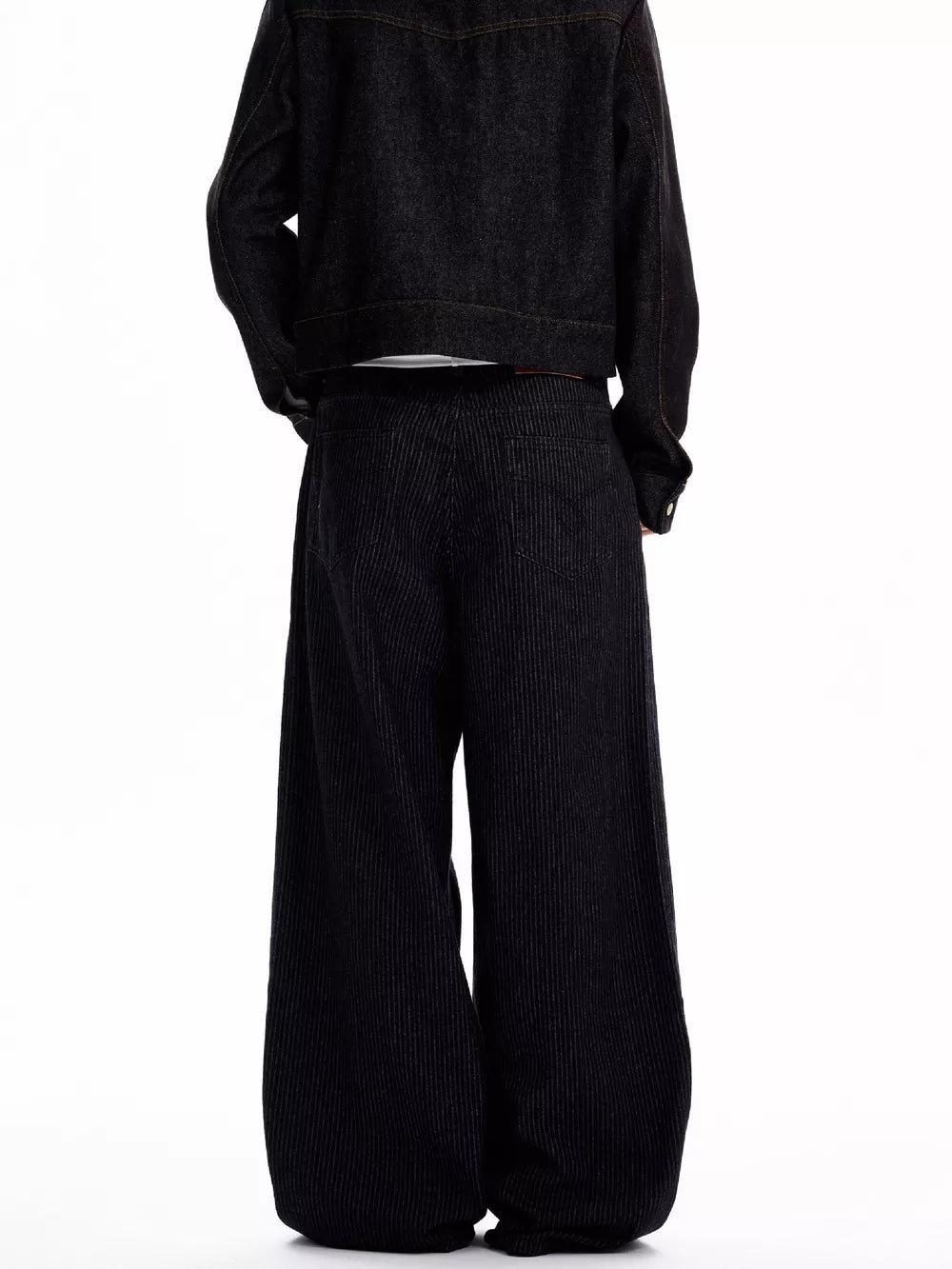 Men's black high-waisted wide leg jeans with vertical pinstripe detail.