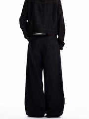 Men's black high-waisted wide leg jeans with vertical pinstripe detail.