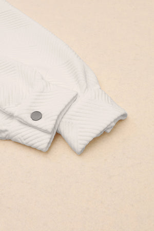 Textured ivory overshirt detail showing cuff and button closure.