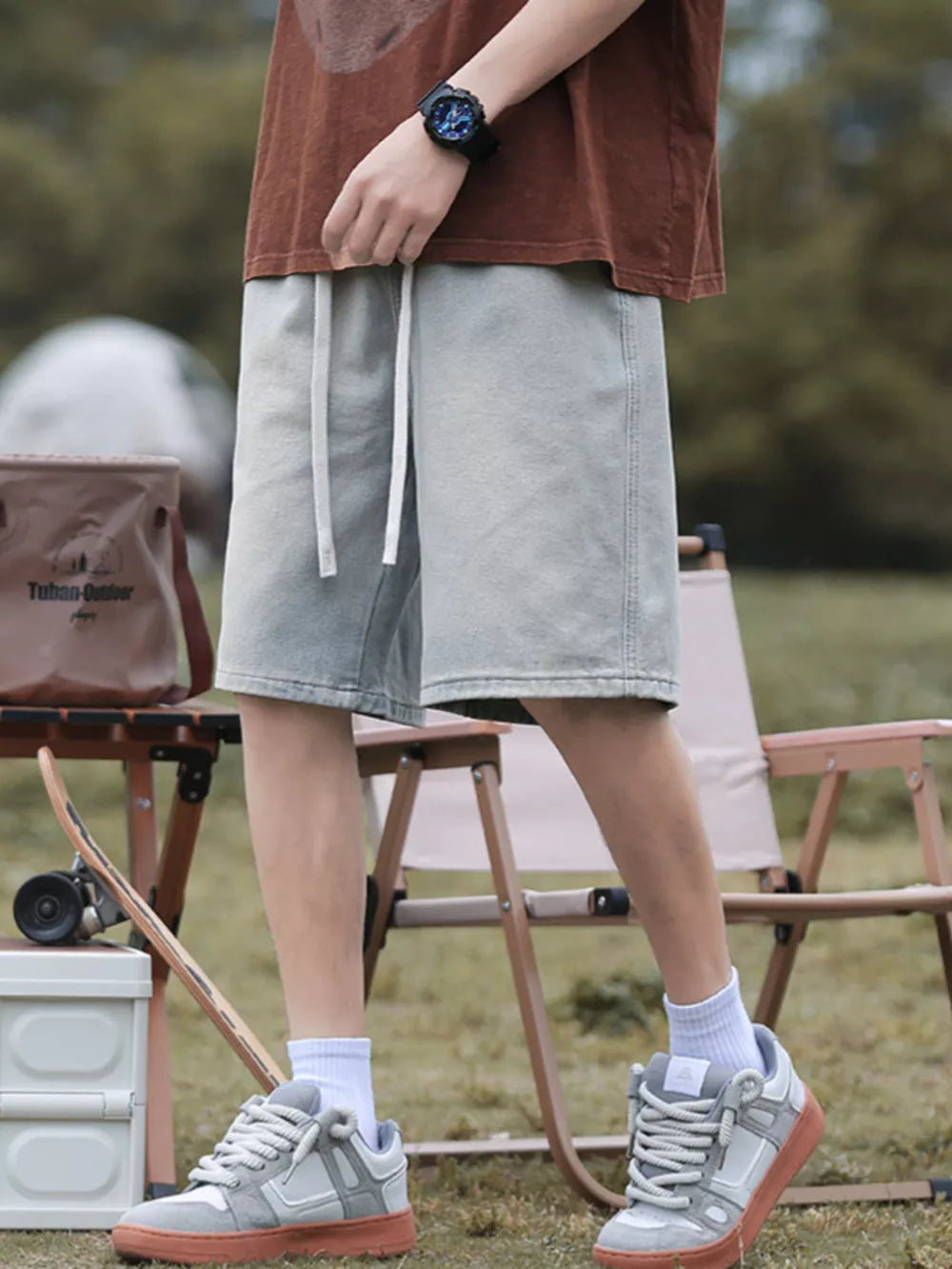 Light blue relaxed fit denim shorts with drawstring waist and pockets.