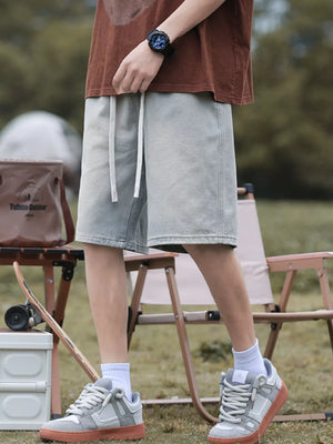 Light blue relaxed fit denim shorts with drawstring waist and pockets.