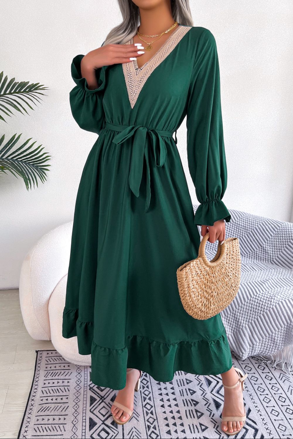 Forest green midi dress with lace trim V-neck, tie waist, and ruffled hem.