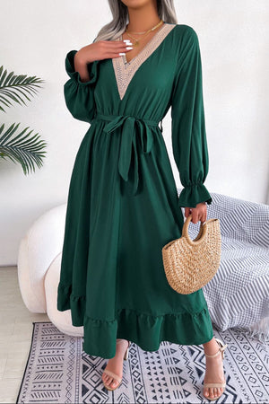 Forest green midi dress with lace trim V-neck, tie waist, and ruffled hem.