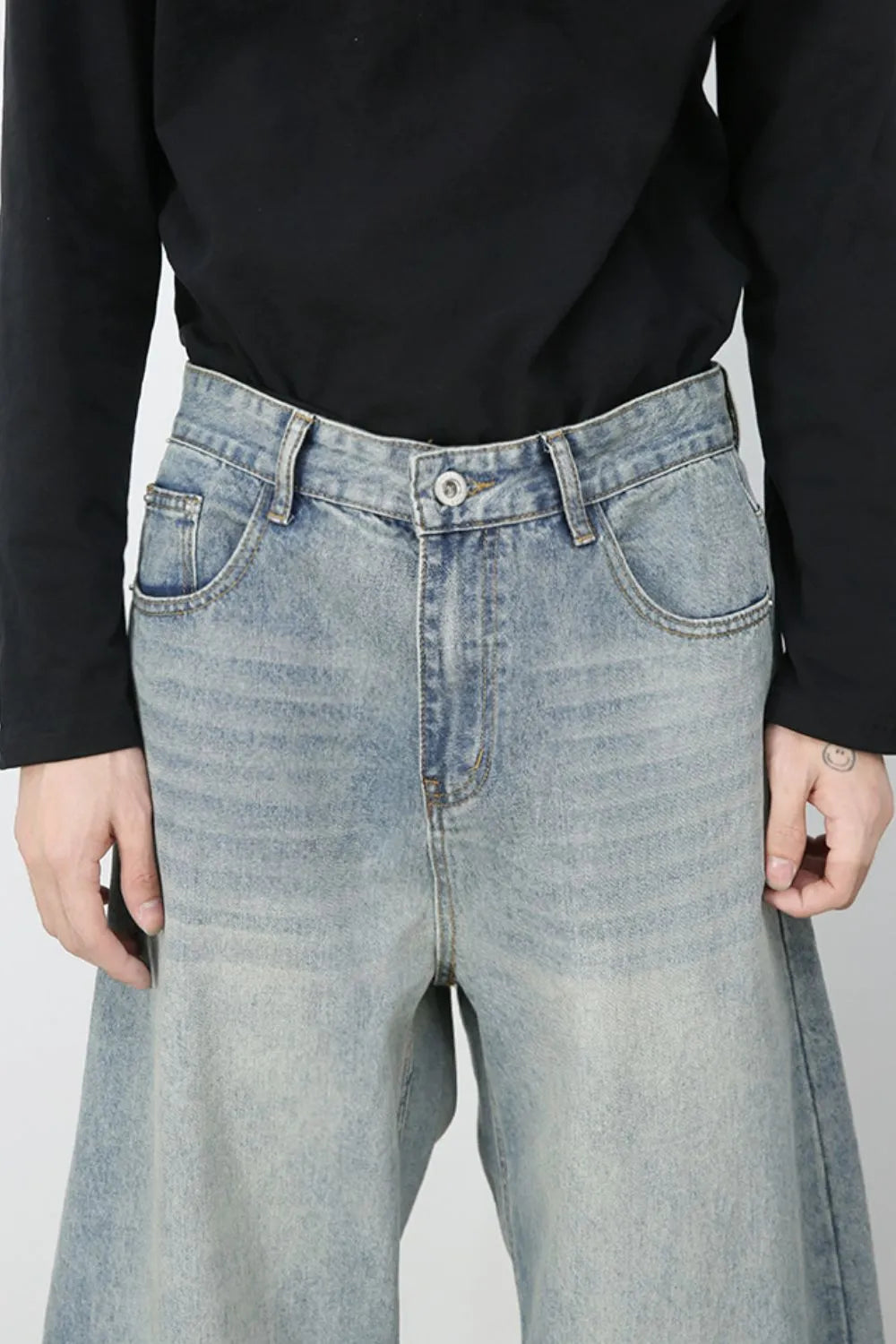 Faded light blue baggy denim jeans with a relaxed fit and classic five-pocket styling.