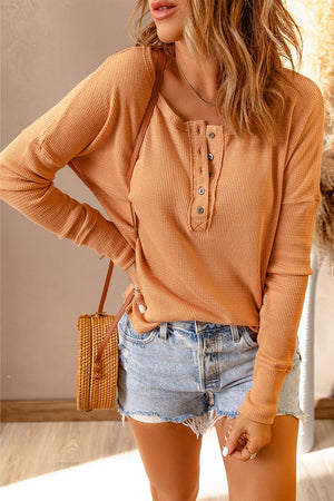 Tangerine ribbed henley drop shoulder top with button detail and long sleeves.