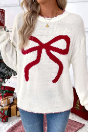 White acrylic knit sweater with a large red bow graphic and contrast red stitching.