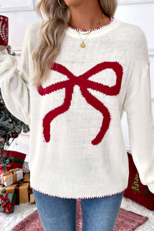 White acrylic knit sweater with a large red bow graphic and contrast red stitching.