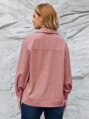 Pinkish corduroy button-up jacket with textured fabric and a classic collar.