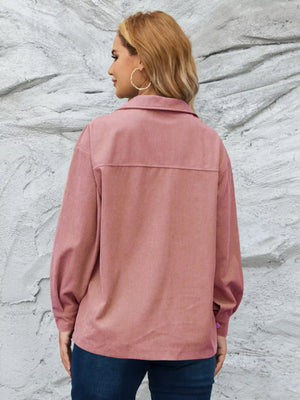 Pinkish corduroy button-up jacket with textured fabric and a classic collar.