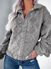 Gray textured fleece quarter zip sweatshirt with diamond pattern and ribbed collar detail.