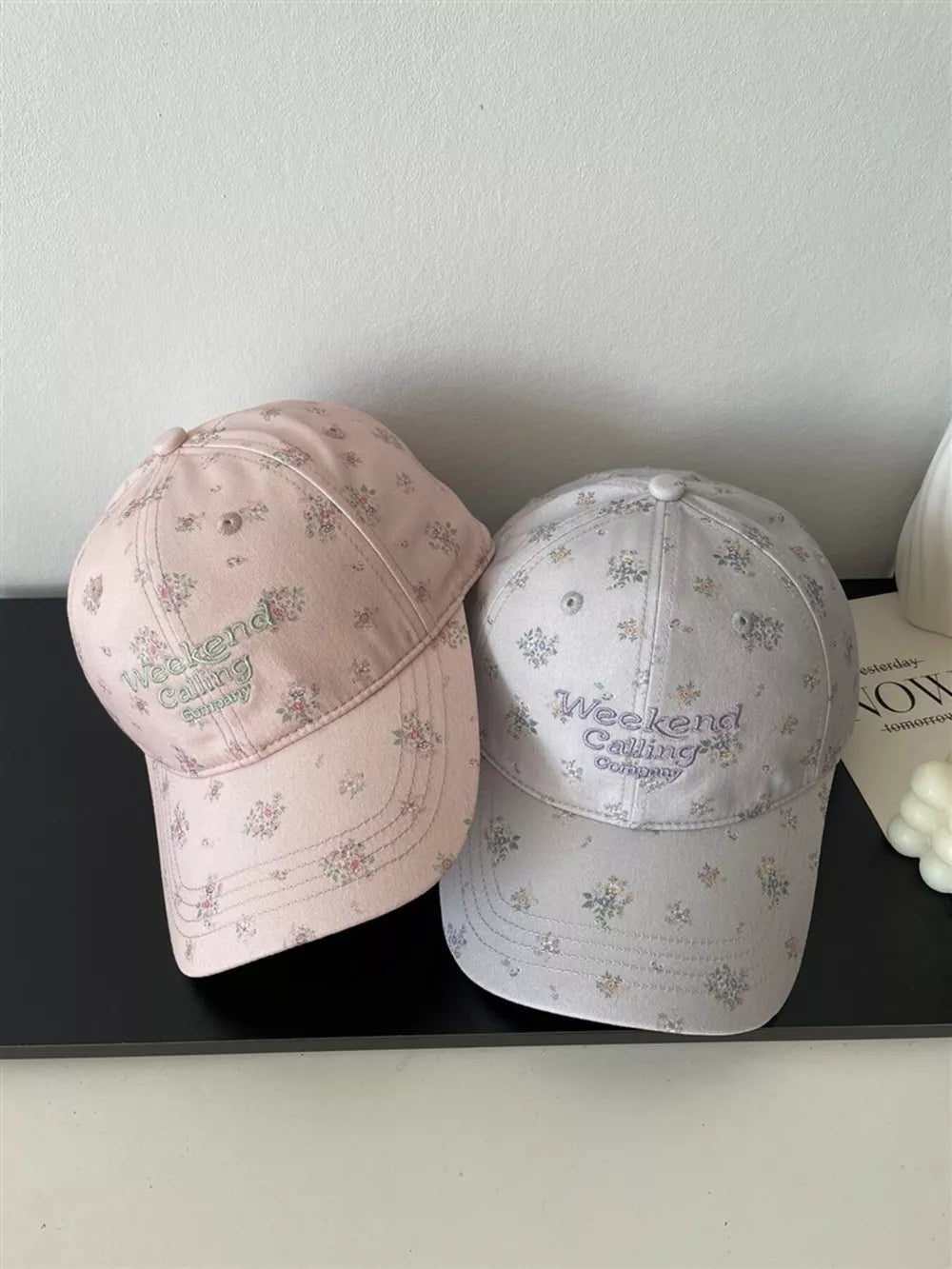 Pink and light gray embroidered floral baseball caps with text detail