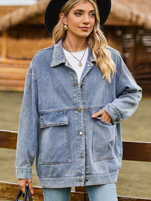 Oversized light wash denim trucker jacket with collared neck and chest pockets.