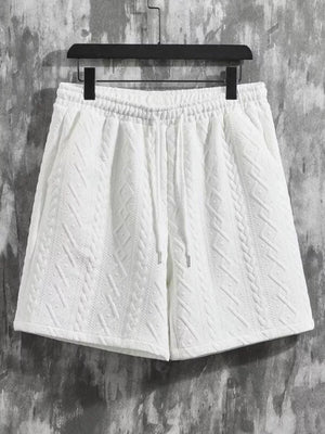 White textured knit shorts with drawstring waist and cable knit pattern detail.