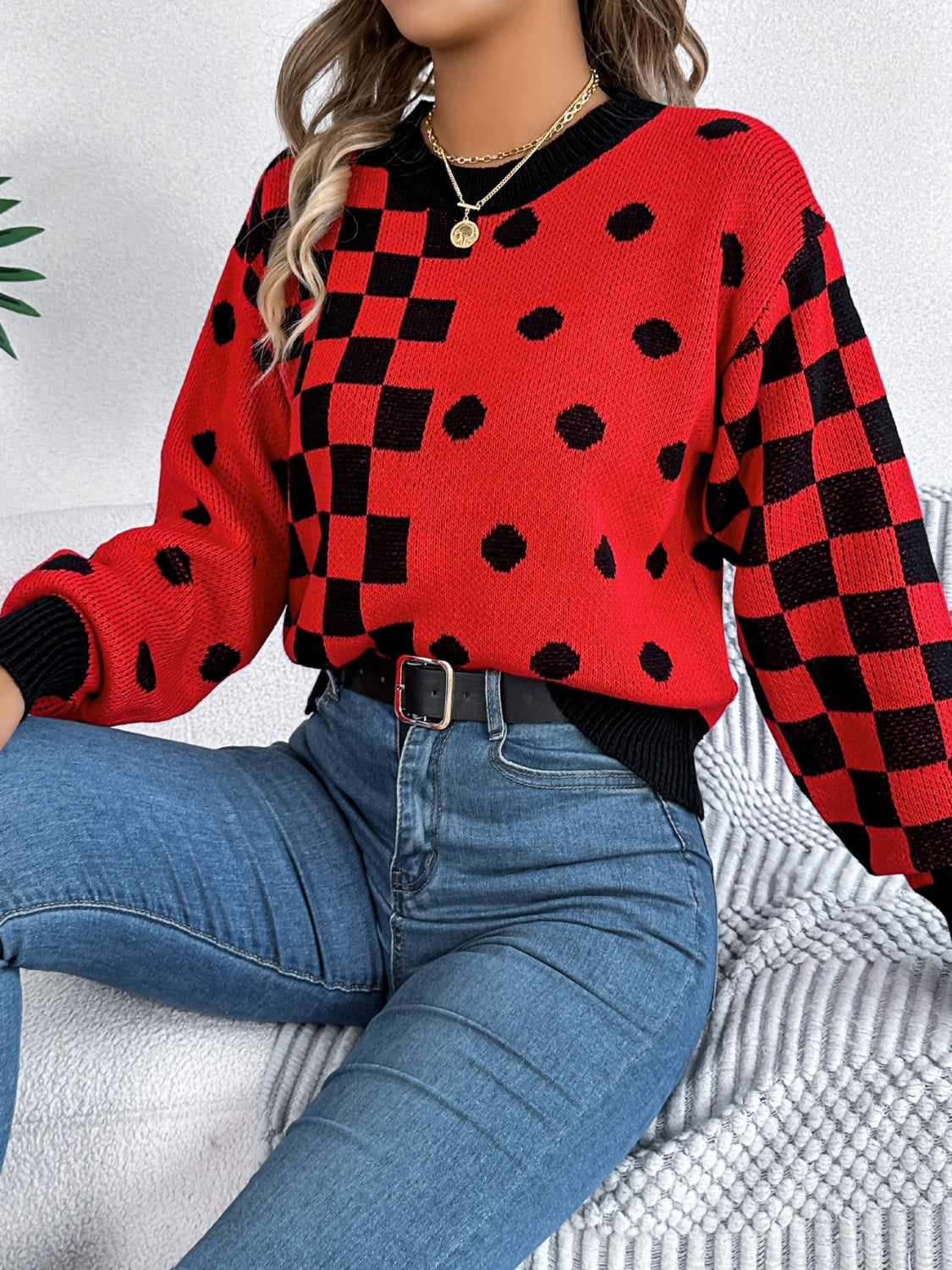 Red checkerboard and dot intarsia knit sweater with crewneck and long sleeves.