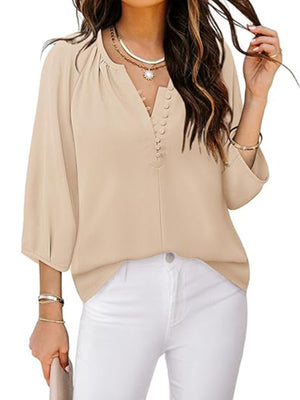 Tan blouse with notched V-neck, button detail and 3/4 sleeves.