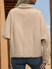 Teddy fleece duffle jacket in apricot with a collared neckline and buttoned front, shown from the back.