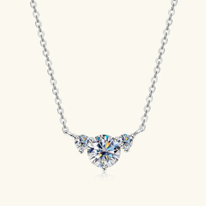 Silver necklace with three round cut diamonds in a graduated setting.