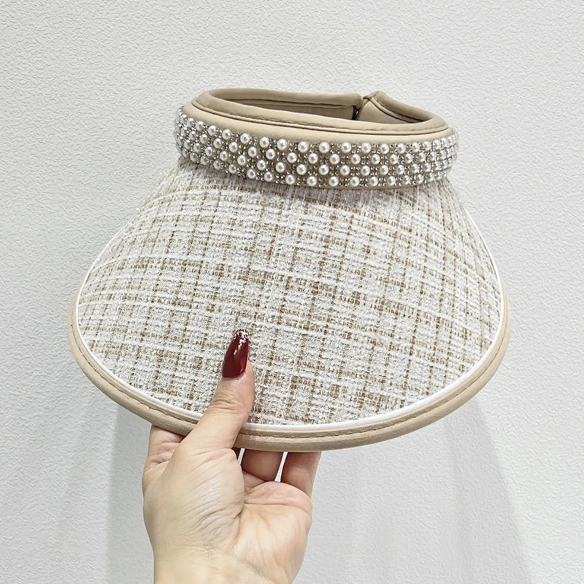 Beige tweed visor with pearl embellishments and a wide brim