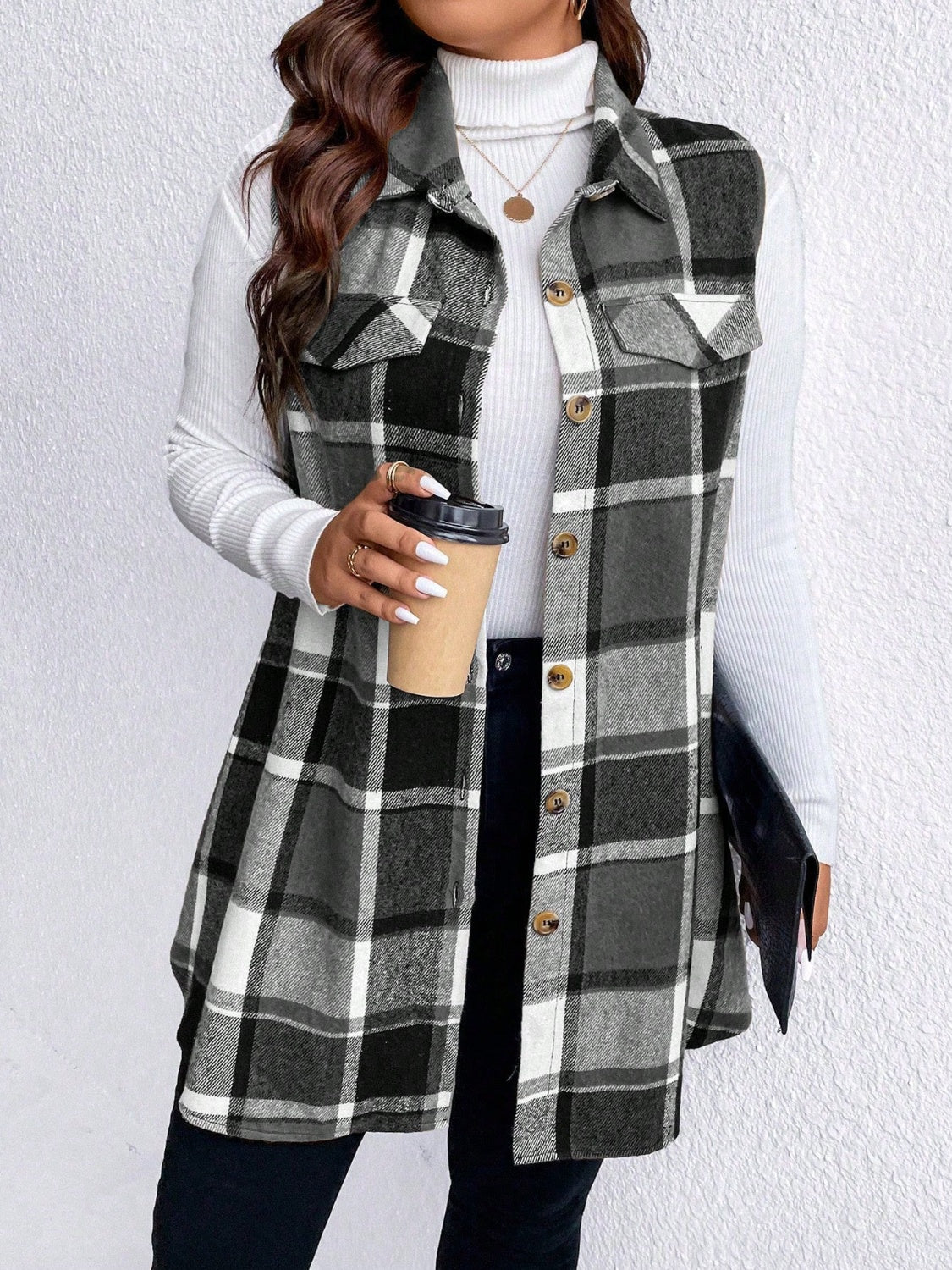 Oversized plaid shirt vest in black and white with button front and chest pockets.