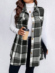 Oversized plaid shirt vest in black and white with button front and chest pockets.