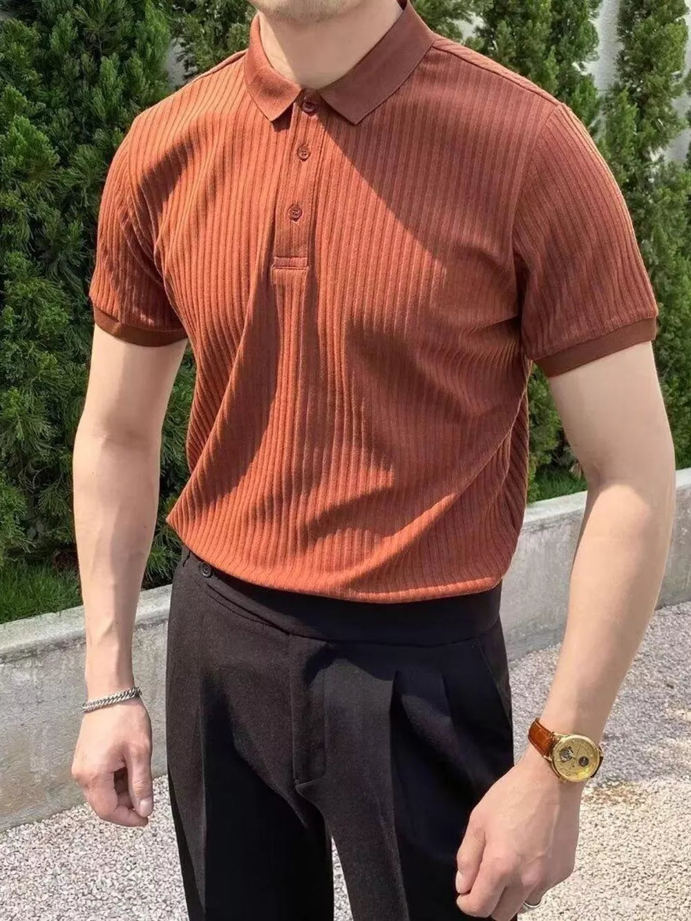 Coffee color ribbed polo shirt with button details and short sleeves.