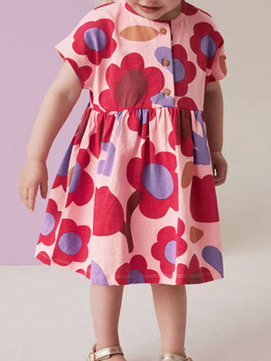 Toddler pink cotton a-line dress with playful red and purple floral print and button-down front.