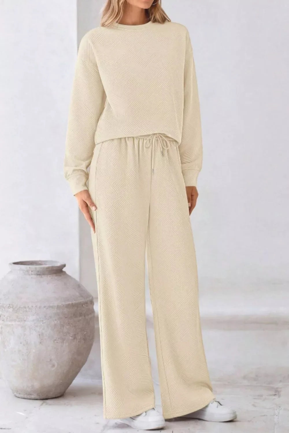 Cozy drawstring lounge set in apricot with a textured pattern and wide-leg pants.