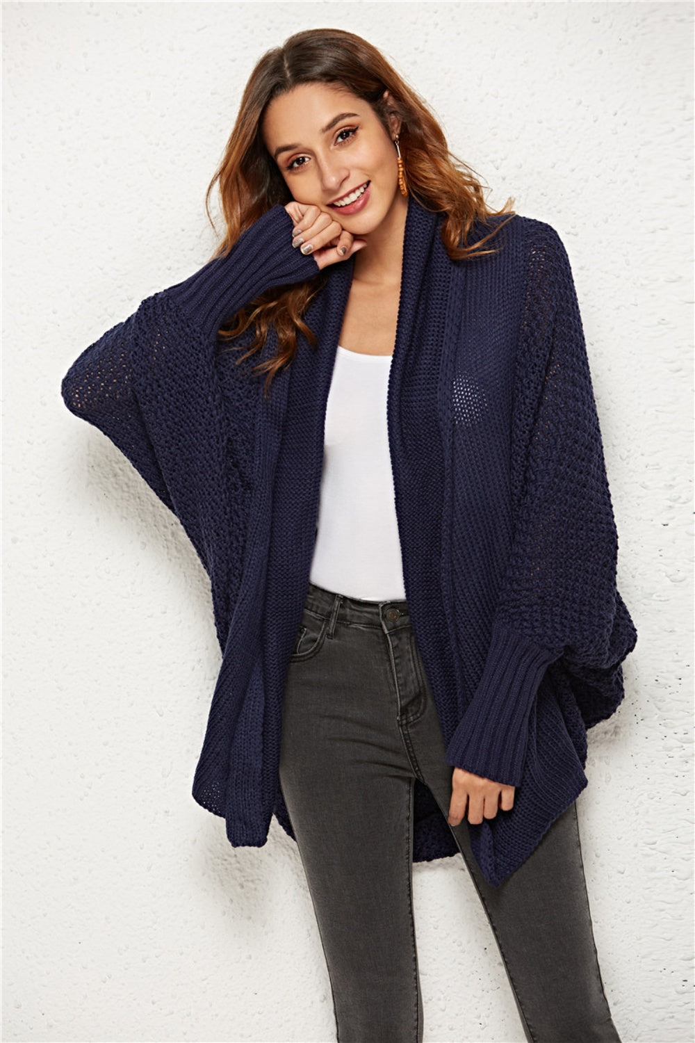 Textured cocoon knit cardigan in dark blue with batwing sleeves and ribbed cuffs.