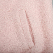 Blush pink textured bouclé bomber jacket with rounded neck and pocket detail.
