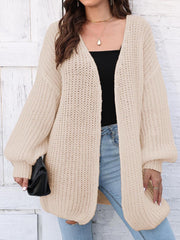 Beige open knit cardigan with balloon sleeves and a relaxed fit.