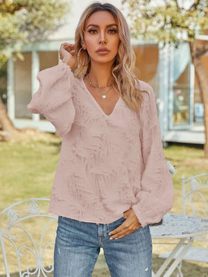 Blush pink textured puff sleeve v-neck blouse with balloon sleeves.