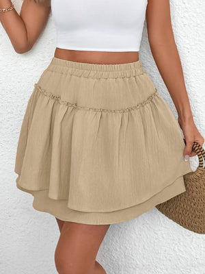 Tiered ruffle mini skirt in tan with an elastic waistband and a flowy, layered hem.