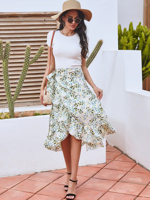 Asymmetric wrap skirt with leaf print in Gum Leaf, featuring a ruffled hem and tie waist.