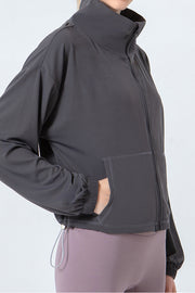 Dark Gray active jacket with gathered hemline, zip front, and pockets.