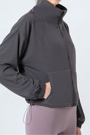Dark Gray active jacket with gathered hemline, zip front, and pockets.