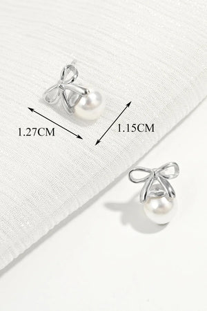 Silver bow pearl drop earrings with detailed measurements shown.