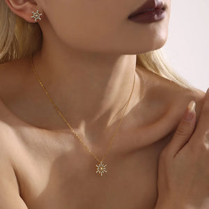 Celestial Snowflake Pendant Necklace with gold chain and matching earrings.
